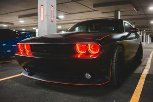 stylish automobile with glowing headlights on parking, valet services, atlanta strip club
